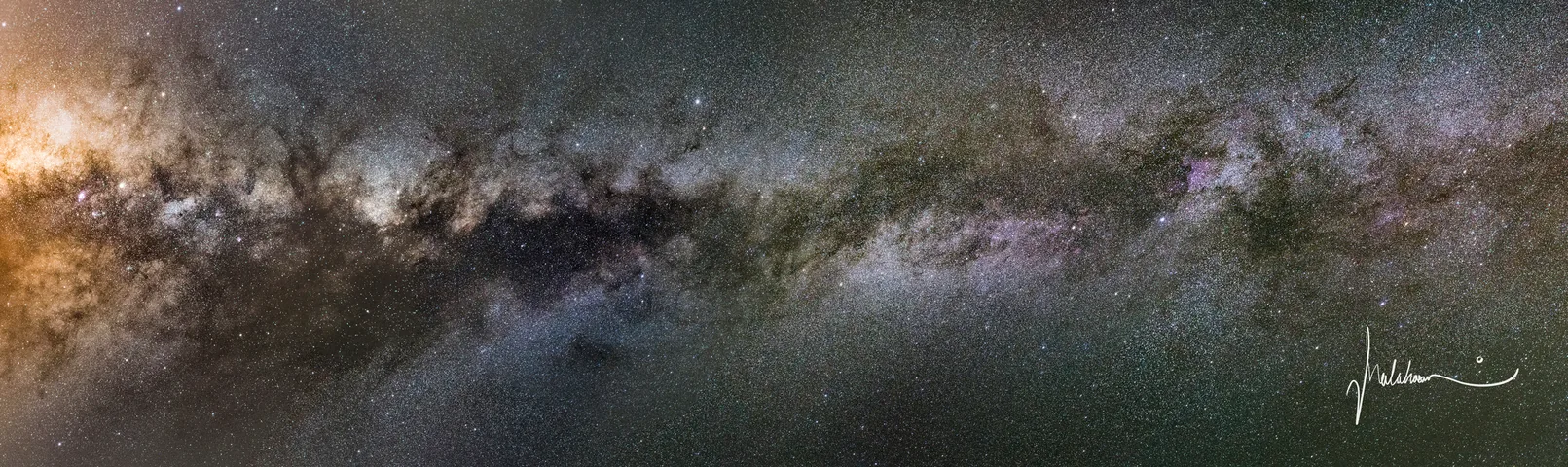 A long panorama of the Milky Way's bright core and dark dust lanes.